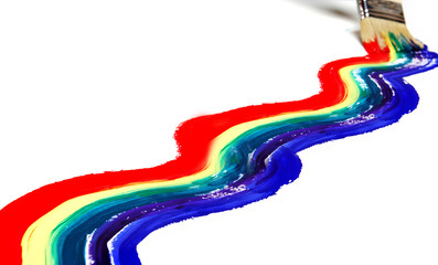 Rainbow paint and brush on white