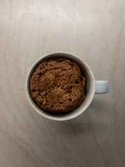 Healthy chocolate mug cake. Top view of a chocolate mug cake made with istante oats, protein powder and egg white. Fit food. Concept of Fitness food 