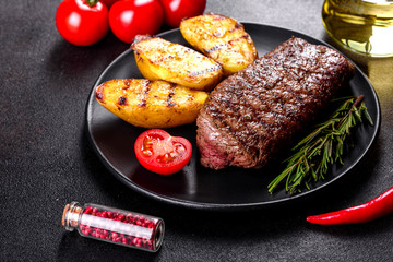 Ribeye steak with potatoes, onions and cherry tomatoes