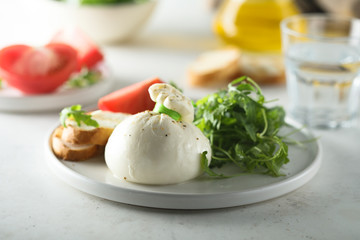 Italian cheese salad with tomatoes and arugula