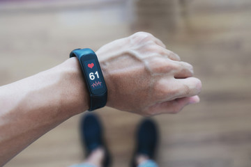 Smart fitness tracking and watch. a man using smart band tracking heart rate and health data