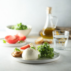Italian cheese salad with tomatoes and arugula