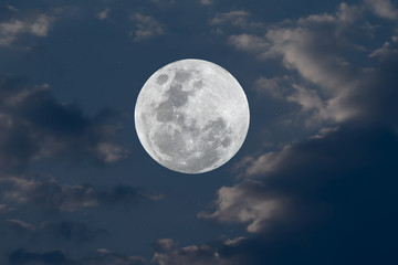 Fototapeta na wymiar Full moon and blurred cloud on blue sky.