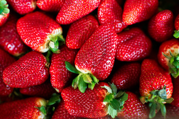 Strawberry. Fresh and ripe organic Strawberries Background, Vegetarian healthy food backdrop. Close-up