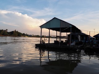 Sunset from a river over fishing village in chau doc, vietnam