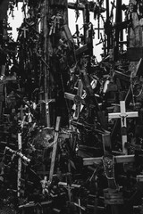 Numerous crucifixes on the hill of crosses in Lithuania. Concept of death, despair, and destruction. Black and white