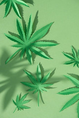 Cannabis leaf made of paper on green background