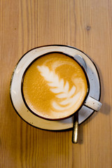 Cup of cappuccino on wooden background