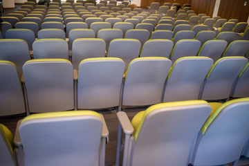 Fototapeta premium Assortment of chairs stacked in a row