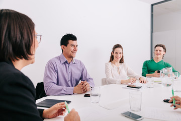 Group of office workers at a meeting around the boss