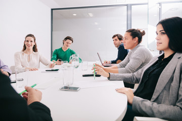Group of office workers at a meeting around the boss