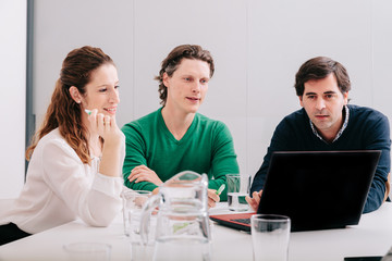 Group of office workers at a meeting around the boss