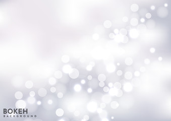 Abstract blured silver bokeh background sparkling lights effect.