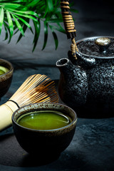 Matcha Green Tea in Bowl with Bamboo Whisk