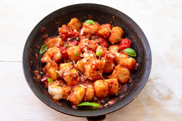 Gnocchi with tomato sauce and garnshied basil and cheese