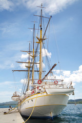 Fototapeta na wymiar White sailboat moored at the pier in the city of Tivat, Montenegro.