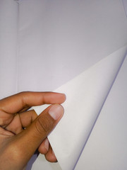 blank white page turning by hand