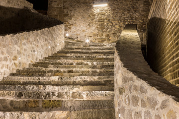 Inside view of the beautifully lit ancient fortress with reconstructed walls and stairs