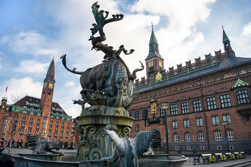 Fountain with bronze sculpture of bull and dragon on City Hall Square in Copenhagen, Denmark. February 2020