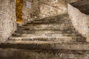 Inside view of the beautifully lit ancient fortress with reconstructed walls and stairs