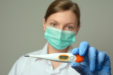 Doctor with mask and thermometer