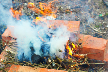 bonfire flames up in the hearth of bricks