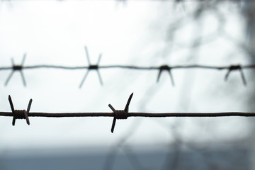barbed wire is stretched by horizontal lines