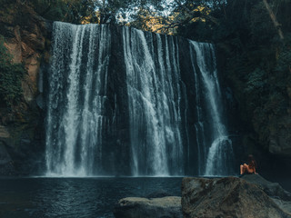 Girl looking at the waterfall