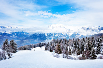 Alpine ski slope and mountain range peaks of Mont-Blanc, Chamonix region, Auvergne-Rhone-Alpes in...