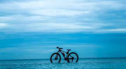 silhouette of bicycle on beach