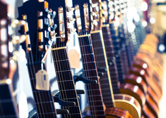 row of new acoustic guitars in music shop