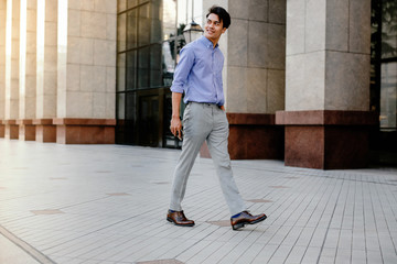 Happy Young Businessman in Casual wear Walking in the City. Lifestyle of Modern People. Full Length