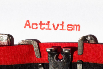 Activism typed on typewriter on red