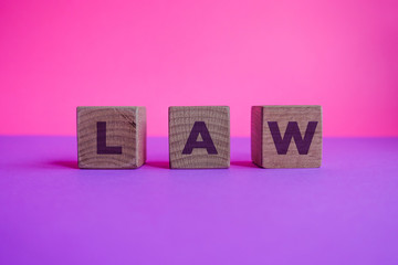 LAW, Wood Blocks on Pink and Lilac Background.