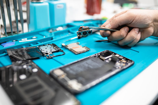 Professional smart phone repair shop or service. Close up shot. Electronics concept.