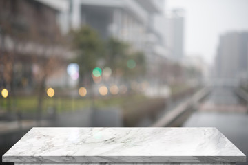 Marble top table with blur big building on background