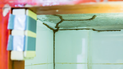 Traces of termites eat wood, Timber beam of door damaged by termite which eat for a long time, The wood home with termites damage in kitchen.