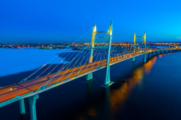 Saint Petersburg. Russia. Bridges Of St. Petersburg. Vansu bridge. Obukhov bridge across the Neva. Neva river under the ice. Evening Petersburg. Road traffic on the bridge.