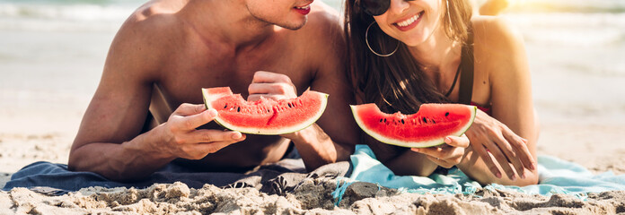 Vacation romantic lovers young happy couple on sand by sea having fun and relaxing together holding...