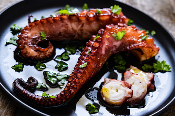 Barbecue octopus on wooden table © Jacek Chabraszewski