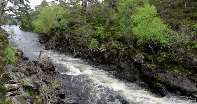 Picturesque landscape of a mountain river with traditional nature of Scotland. 4K Footage.