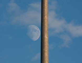 the moon, as if attached to a metal pole