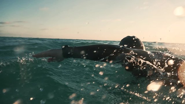 Professional Swimmer Training For Triathlon Competition In Open Water.Professional Triathlete Swimming On Lake At Sunset.Swimmer Underwater.Triathlete Swim Preparing To Iron Man Triathlon Competition