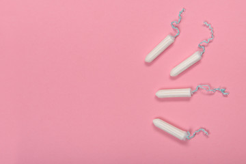 Group of tampons seen from a high angle view on a pink background with space for copy