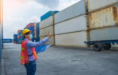 Engineer wearing a helmet standing cargo at the container yard and Check container integrity Before...