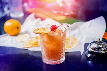 Non alcoholic cocktail with lemon and oranges at wooden bar counter. Restaurant.