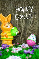 Happy easter greeting card on wooden background