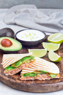 Grilled Quesadilla With Smoked Salmon And Avocado Served With Yogurt And Lime Dip, On Wooden Board, Vertical