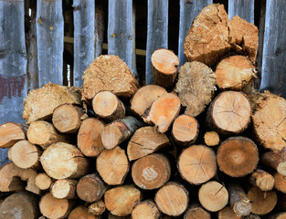 Large rural stack of firewood. Old firewood. Background.