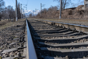 Fototapeta na wymiar Railroad with rails and mountains background